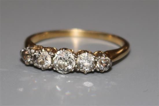 An 18ct gold and graduated five stone diamond ring, size R.